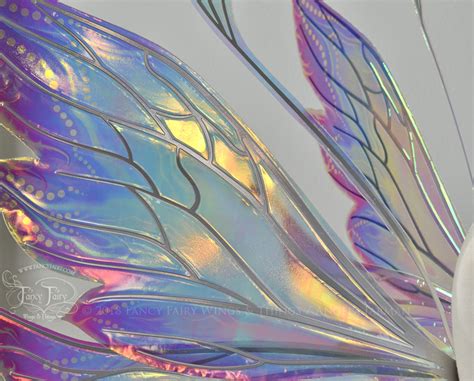 Roll iridescent film smoothly over the veins and vinyl, cut from roll, smooth and press all the bubbles out. . Fairy wings iridescent